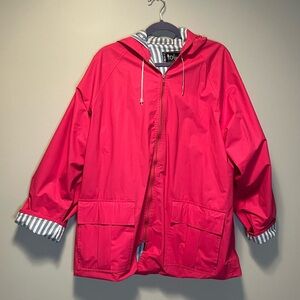 Pink Totes raincoat with blue and white striped lining. Two pockets and hooded.